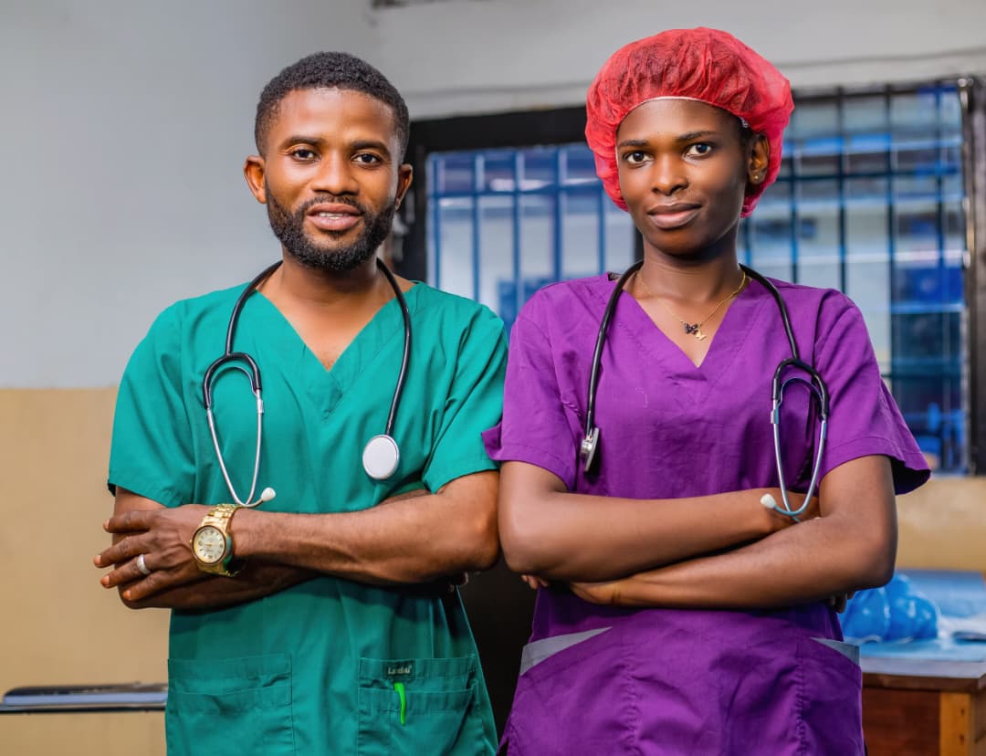 Two clinic staff members in scrubs